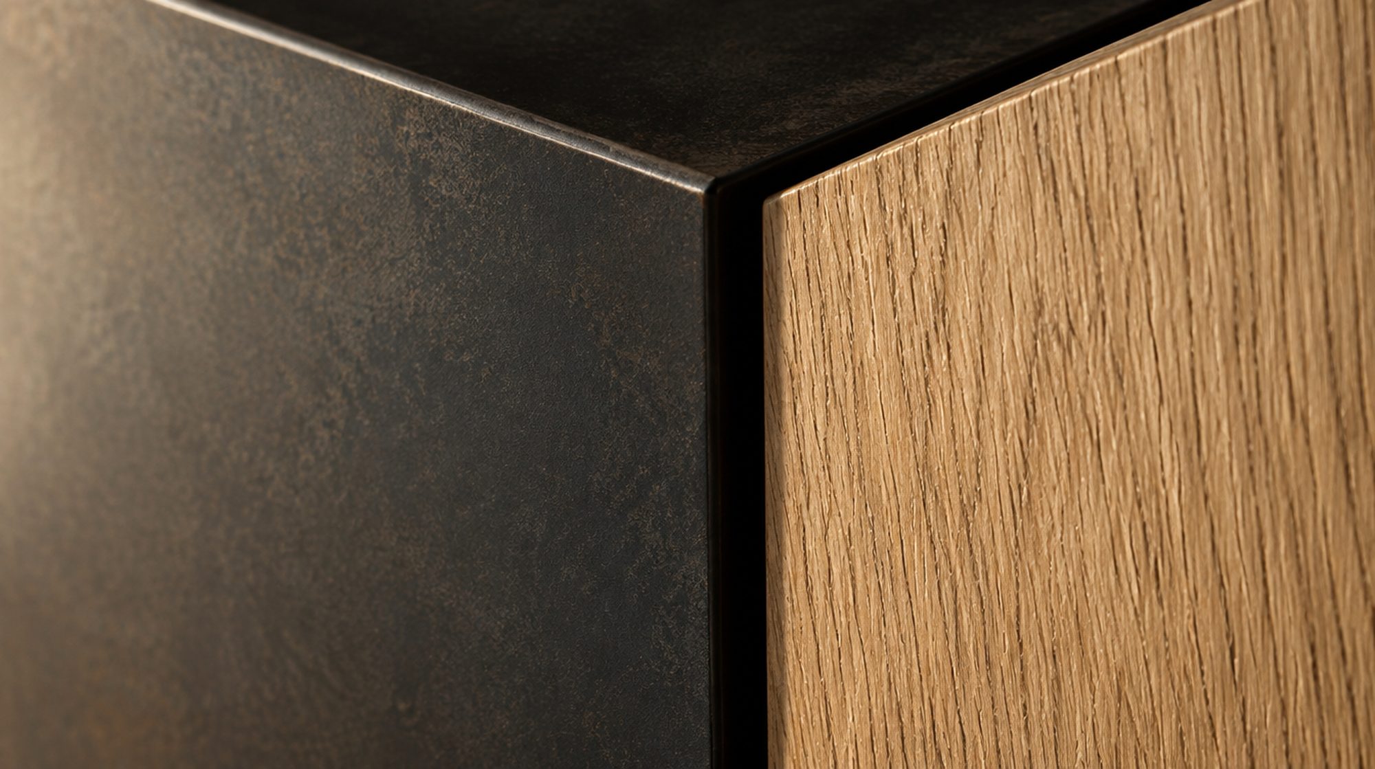 Macro detail of a blackened steel reveal meeting rift-sawn white oak with a crisp shadow gap.